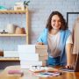Small business owner, entrepreneur, seller using tablet checking ecommerce clothing store orders.